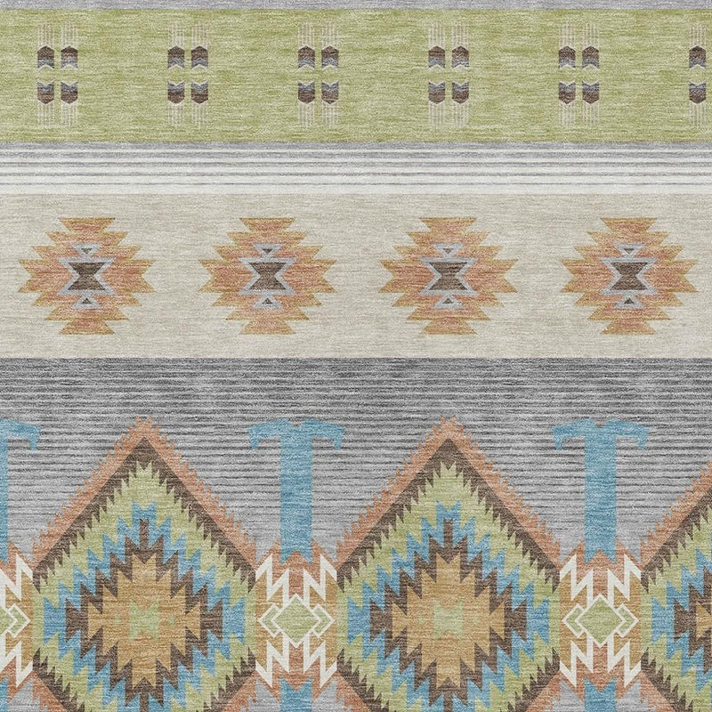 Geometric southwestern area rug close-up with diamond motifs in gray, tan, and blue.