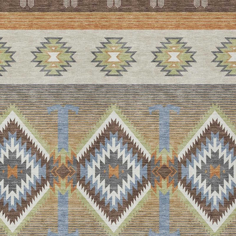 Southwestern area rug close-up with repeating diamond medallions, blue T motifs, and brown trim