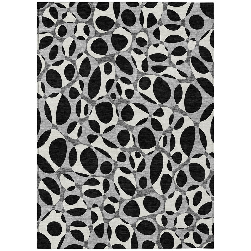 Black and gray abstract area rug with repeating oval ring pattern, full rug view