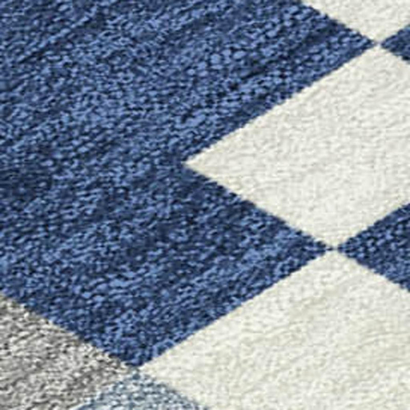 Deep blue and cream geometric section of patchwork area rug with textured weave