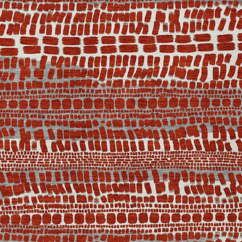 Tight close-up of red and gray brick-style abstract rug pattern