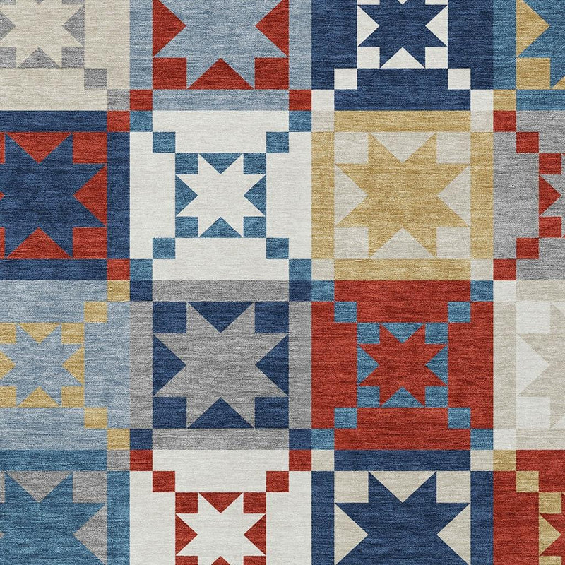 Close-up patchwork rug with star blocks in blue, red, gold, gray, and cream.