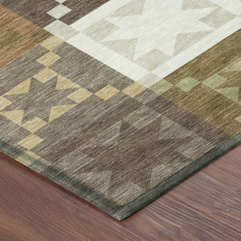 Patchwork area rug corner with star, diamond, and check motif in dark brown and tan