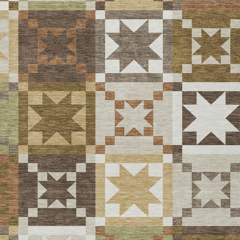 Close-up patchwork area rug with star squares in olive, brown, gray, and white