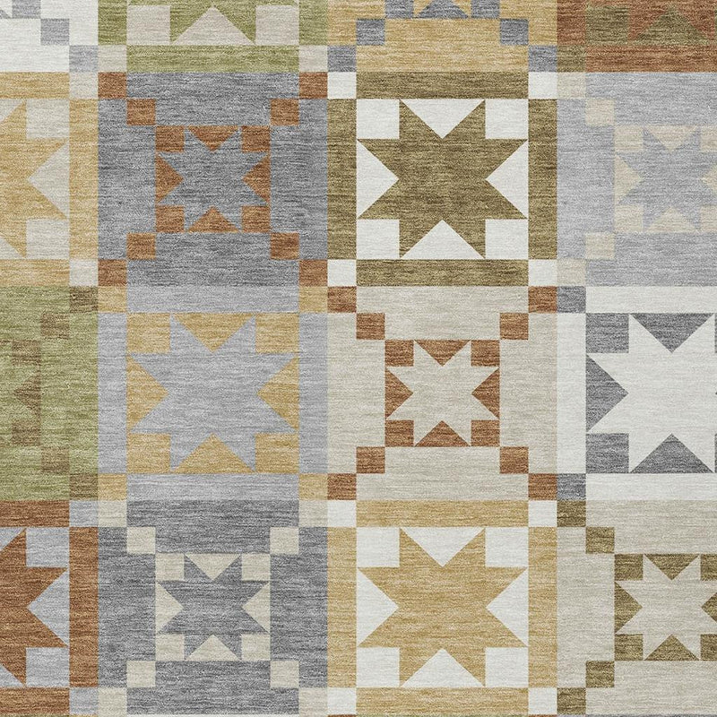 Close-up of patchwork area rug squares with stars in gray, beige, olive green, rust