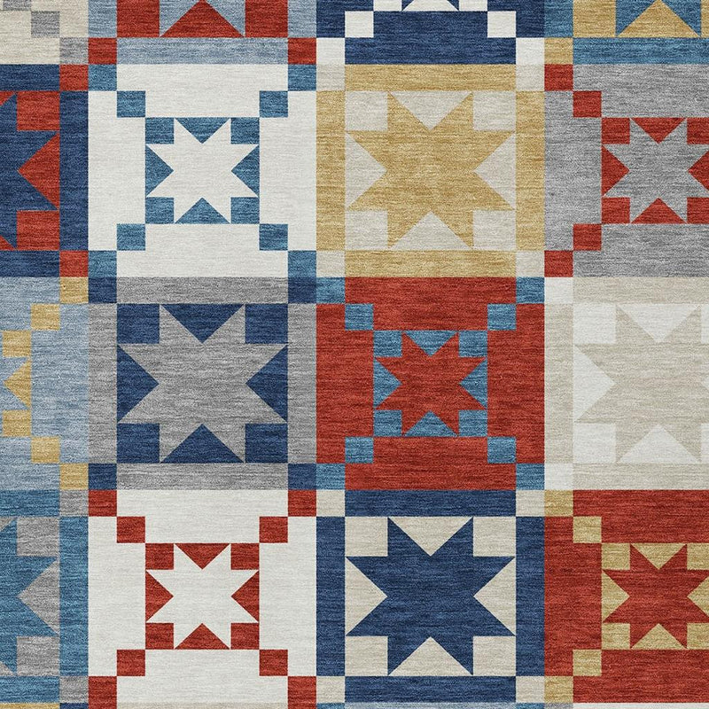 Close view of patchwork area rug with mixed star squares in blue, red, white, and gold tones