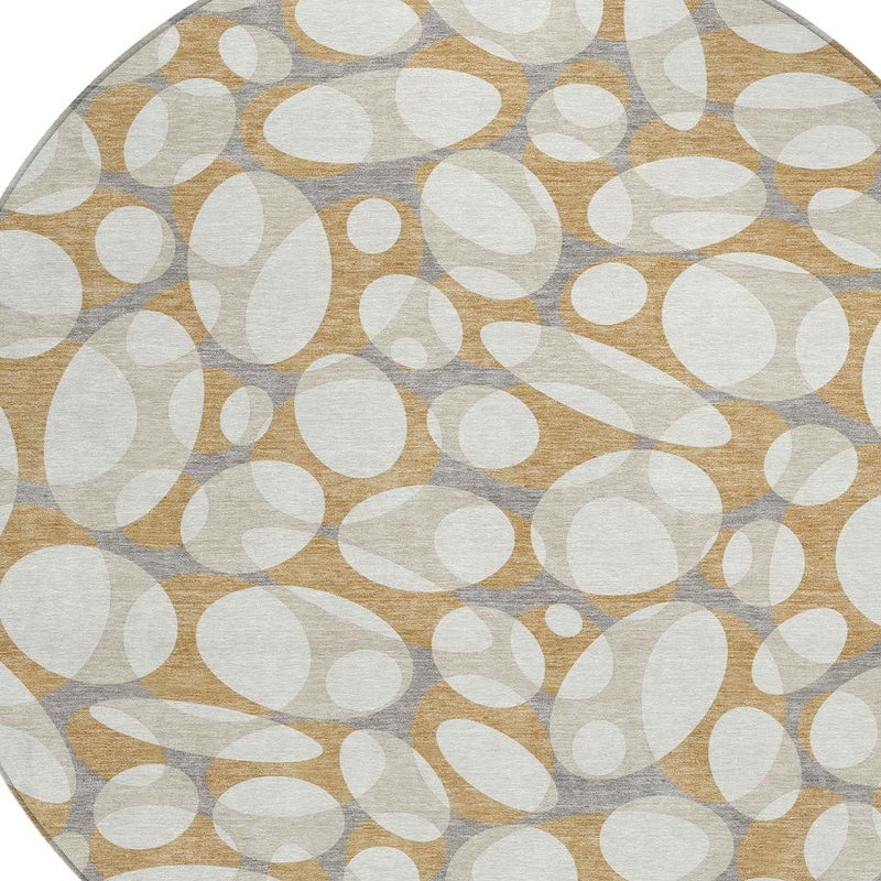 Round area rug pattern close-up of stacked ovals and circles in cream and gold