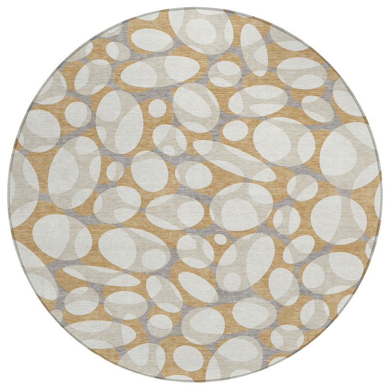 Round abstract area rug with scattered oval circles in beige, gray, and muted gold