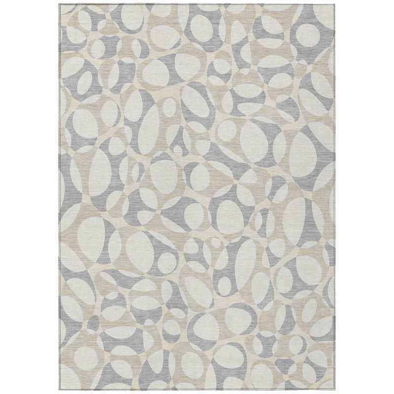 Indoor-outdoor area rug featuring abstract oval pebble pattern in ivory and light gray