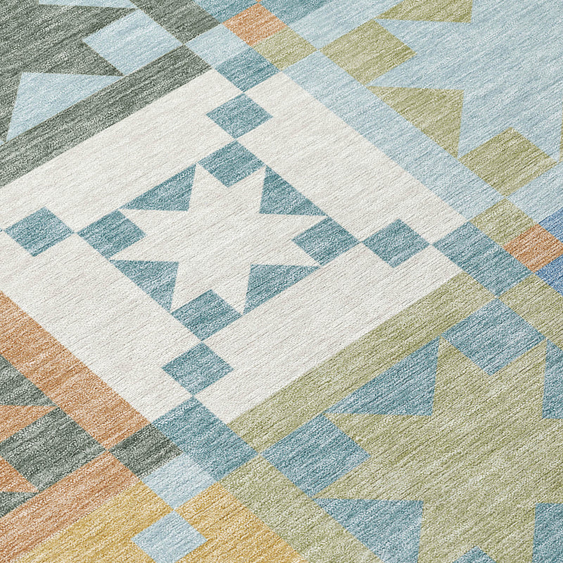 Washable indoor/outdoor area rug close-up with blue, green and cream star lattice