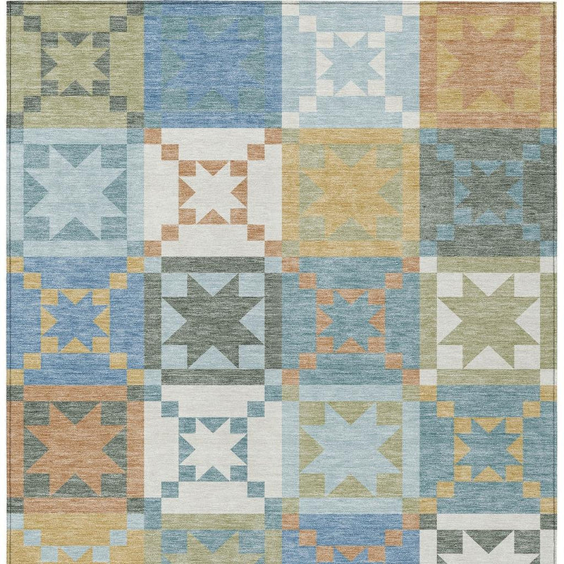 Washable indoor/outdoor area rug close-up of blue, green and tan star patchwork grid
