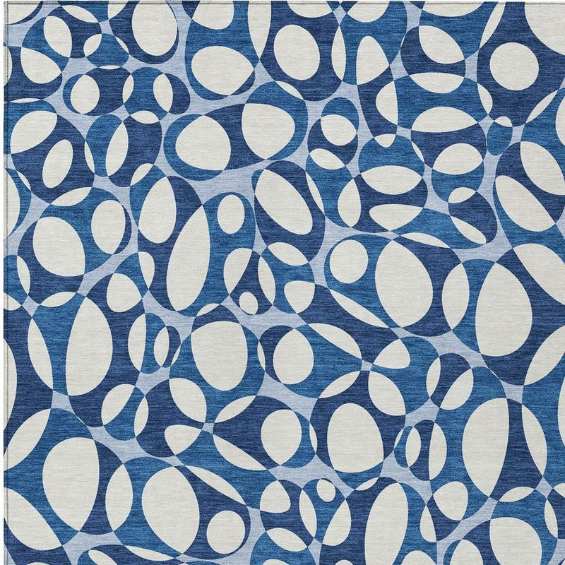 Blue and navy abstract rug with dense overlapping oval shapes, tight pattern view