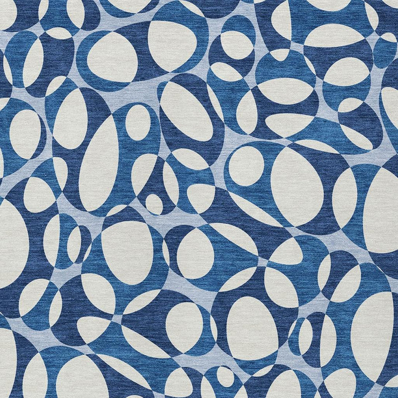 Close-up of blue and navy abstract oval pattern on washable area rug