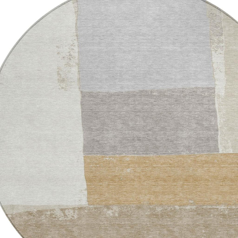 Round area rug with patchwork geometric blocks in light gray, ivory, and beige