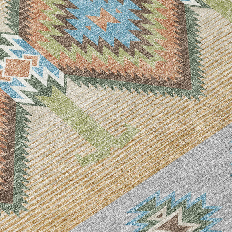 Close-up of copper and silver southwestern area rug texture with teal and green shapes