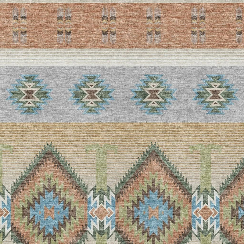 Southwestern area rug close-up with orange border, blue zigzags, green accents, and cream background