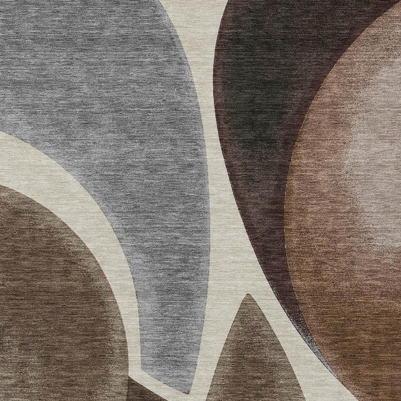 Close-up abstract area rug pattern in gray, brown, beige, with cream curved line details