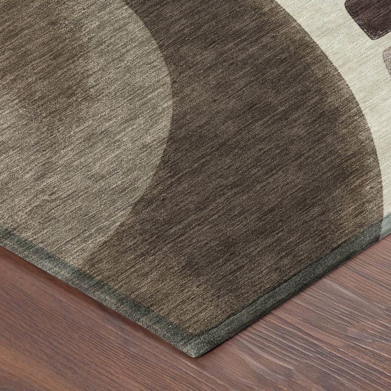Abstract area rug corner on hardwood, showing gray and brown swirls with cream accents