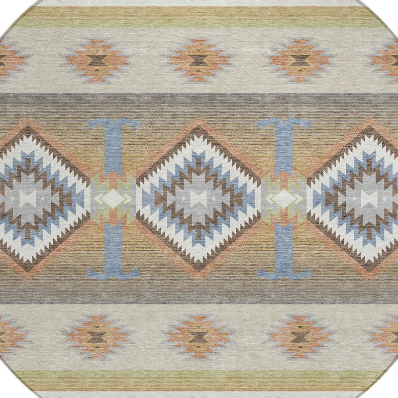 Round area rug close-up of striped bands and diamond motifs in blue, tan, and rust
