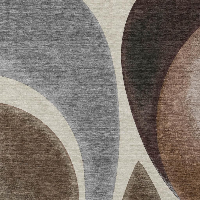 Close-up of abstract rug with gray field, cream arcs, and dark brown curved sections