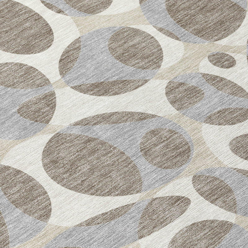 Abstract area rug texture with taupe and brown ovals on light background