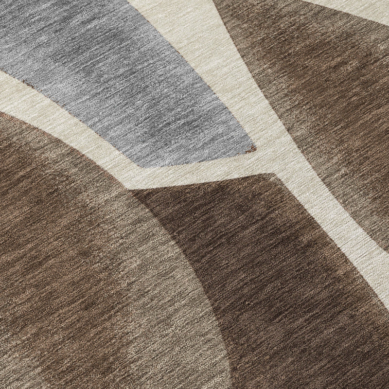 Abstract area rug close-up with textured gray and brown panels and off-white lines