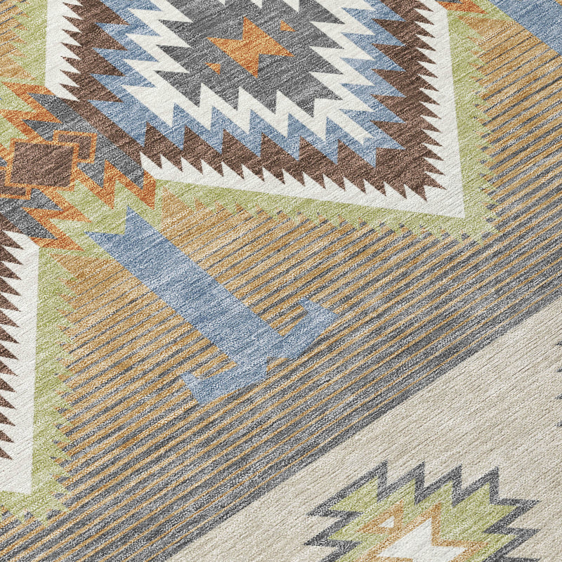 Close-up of southwestern rug texture with diamond motif and muted blue-gray stripes