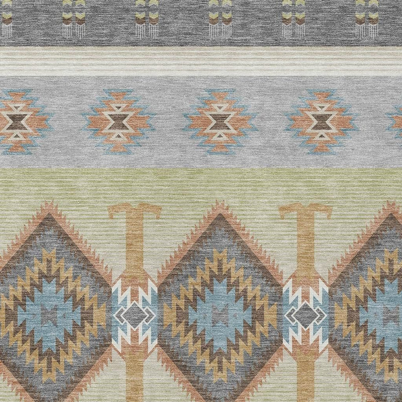 Close-up of southwestern geometric area rug: gray, pale cream, blue zigzag, and green stripes
