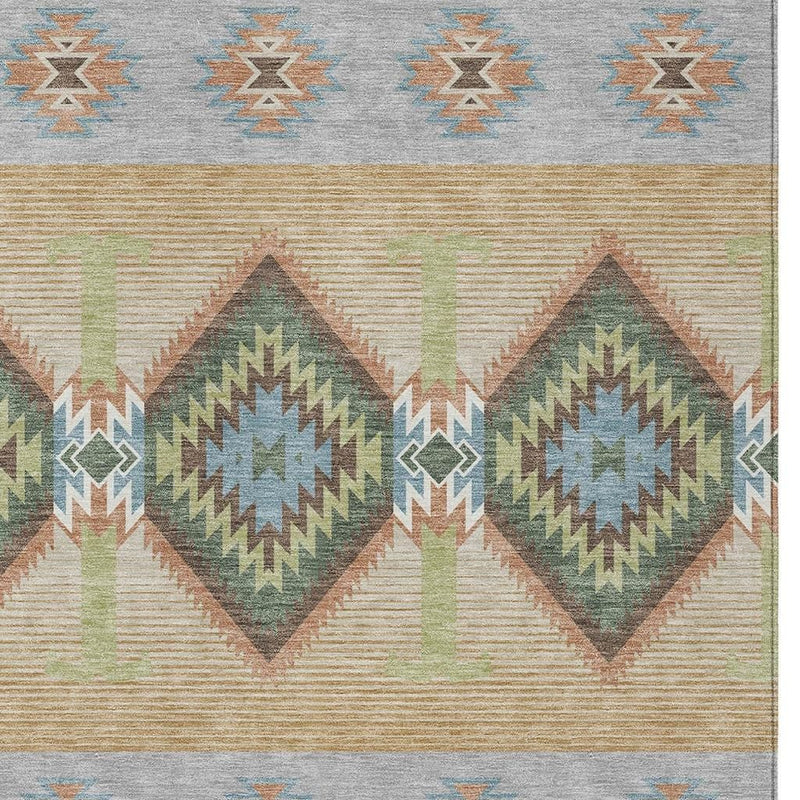 Southwestern area rug detail: diamond patterns in teal, green, tan, and gray