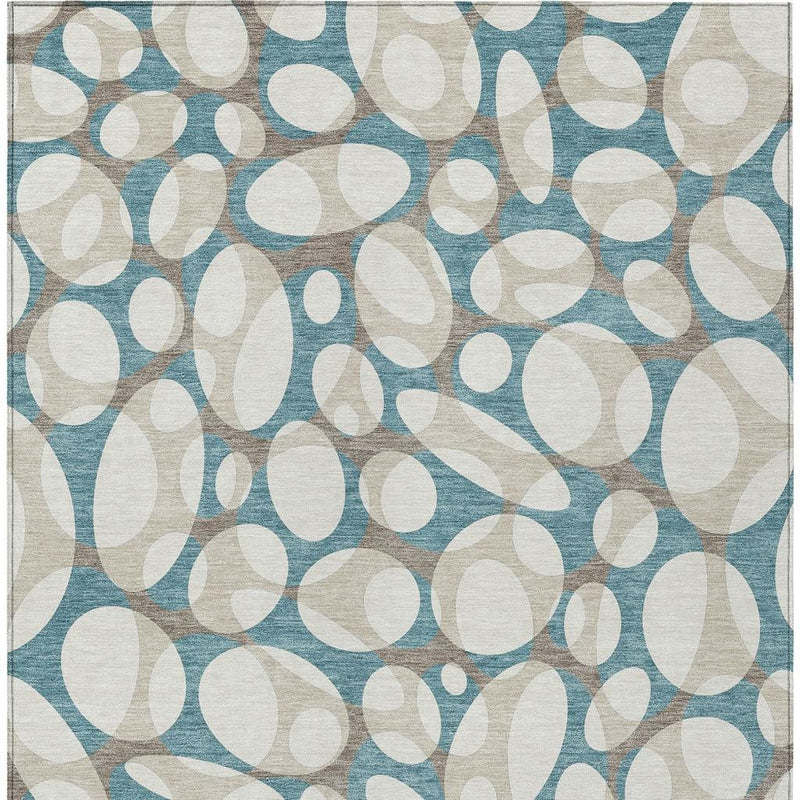 Teal blue and ivory abstract area rug with layered oval shapes pattern