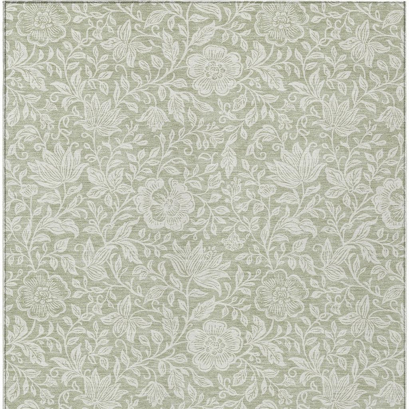 Green and ivory floral area rug close-up, dense leaves and flower details