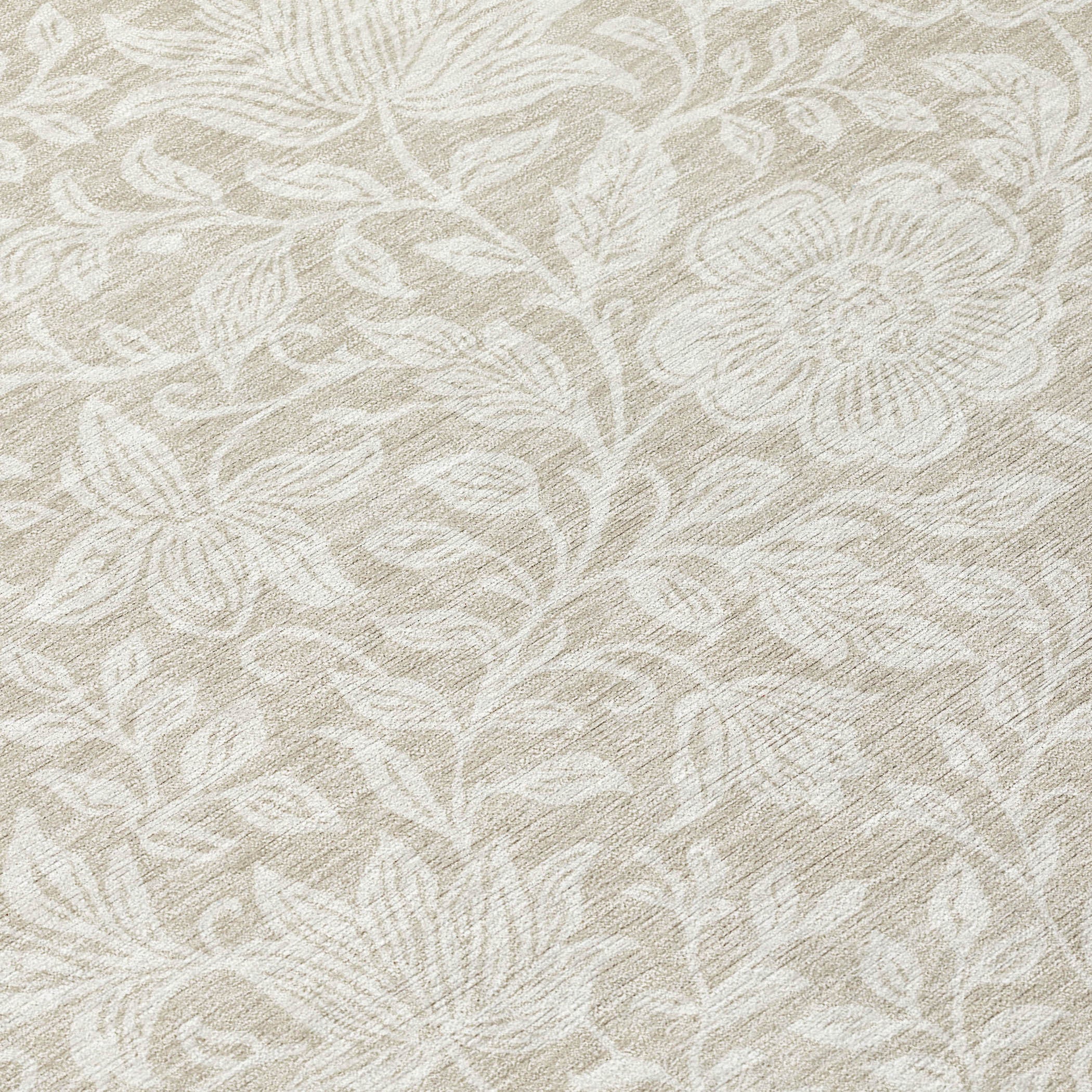Ivory area rug close-up with beige floral and leaf motifs, textured weave