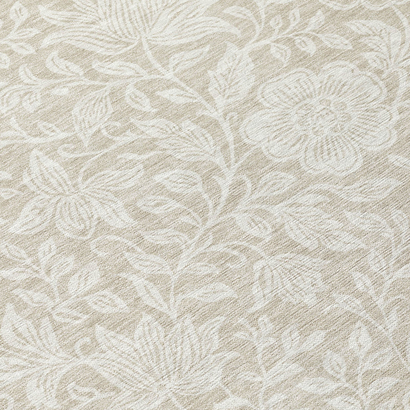 Ivory area rug close-up with beige floral and leaf motifs, textured weave