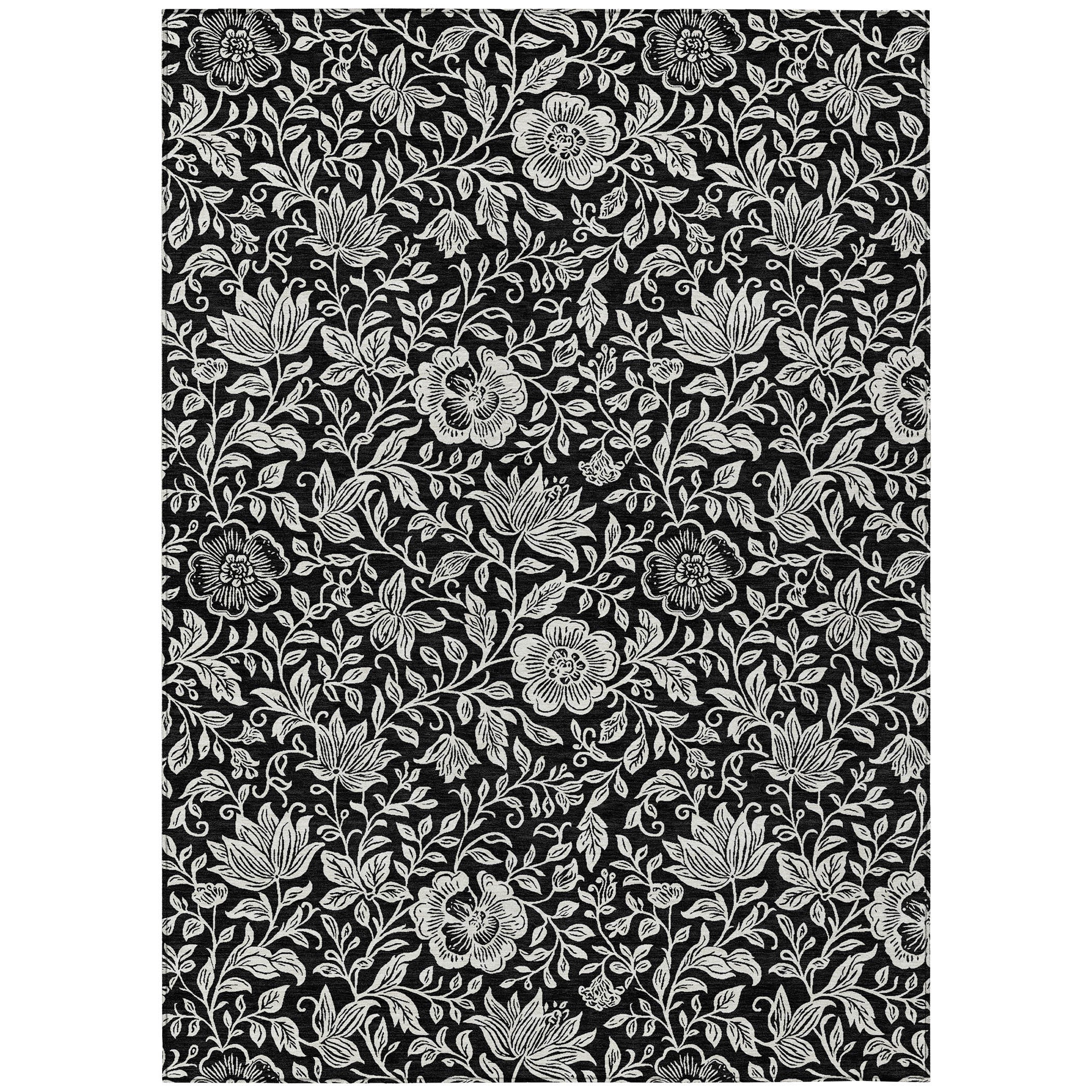 Black and ivory floral area rug with scattered blossoms and fine vine leaves