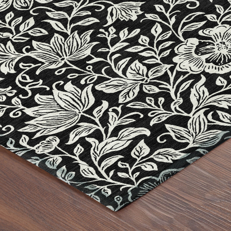 Black and ivory floral area rug with corner detail and flat woven texture
