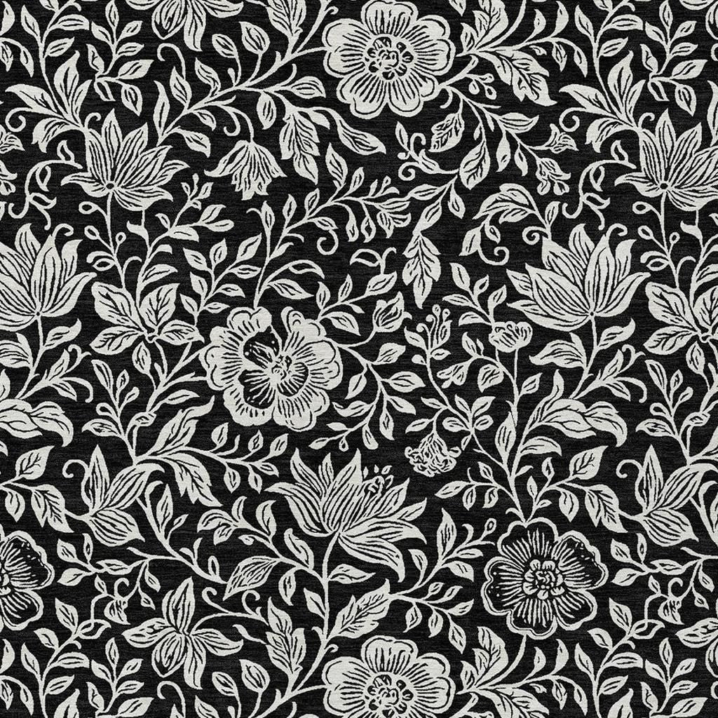 Black and ivory floral area rug with layered blossoms and vine leaves