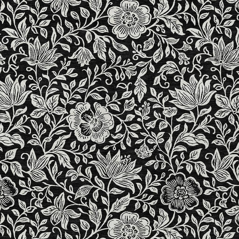 Black and ivory floral area rug with layered blossoms and vine leaves