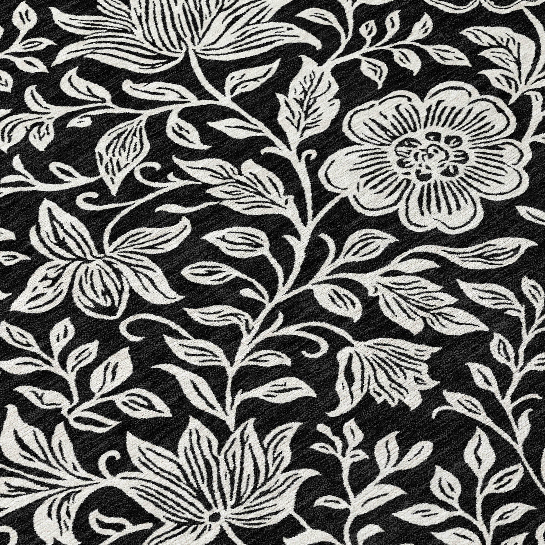 Black and ivory floral area rug with dense leaf and flower pattern