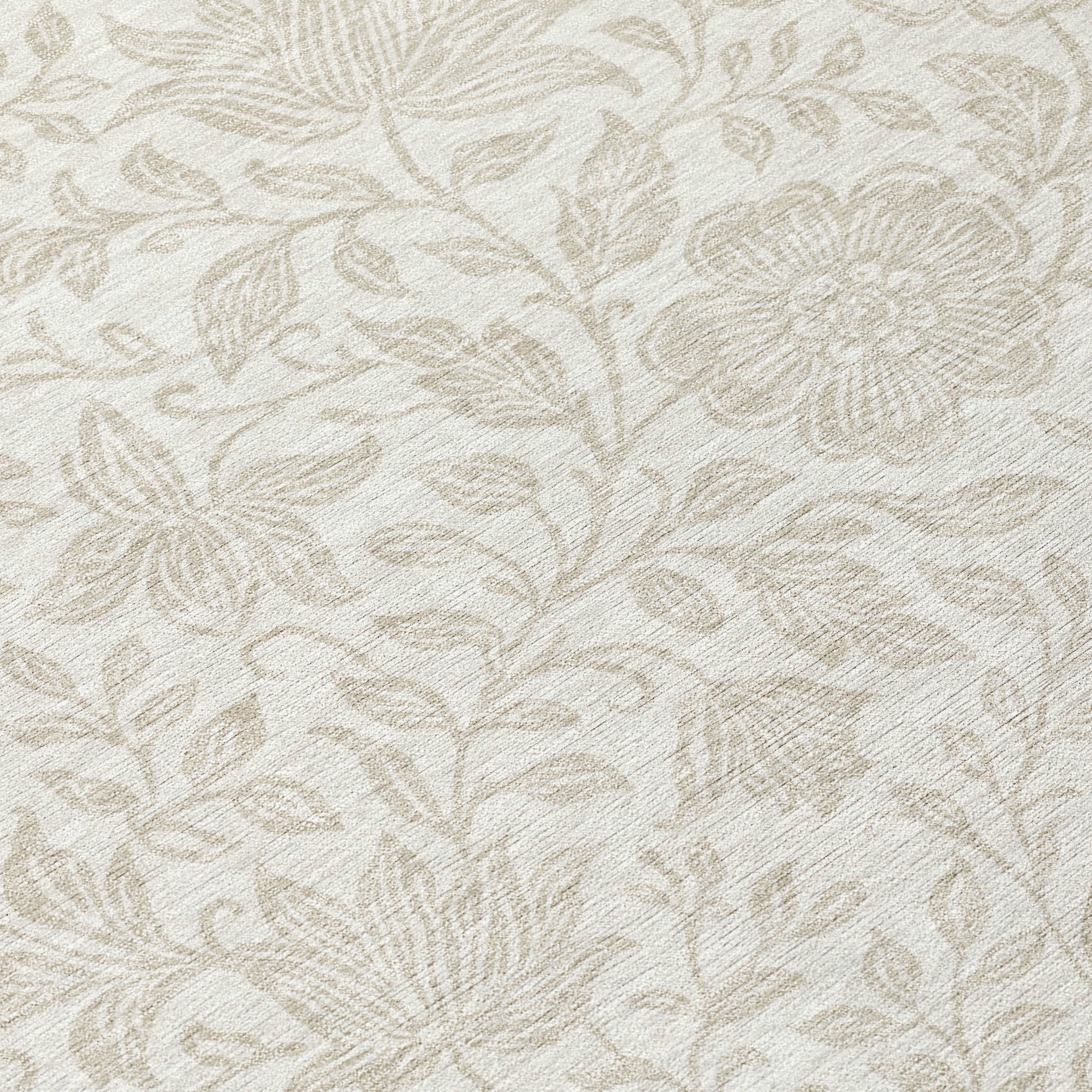 Close-up of ivory and beige floral rug pattern with textured leaves and flowers