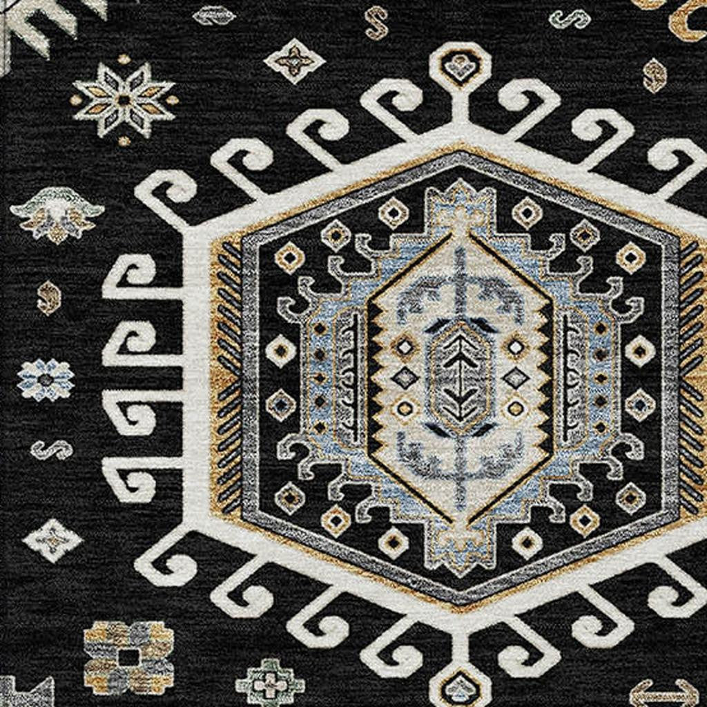 Black area rug with ivory geometric medallion and blue accents, intricate tribal print.