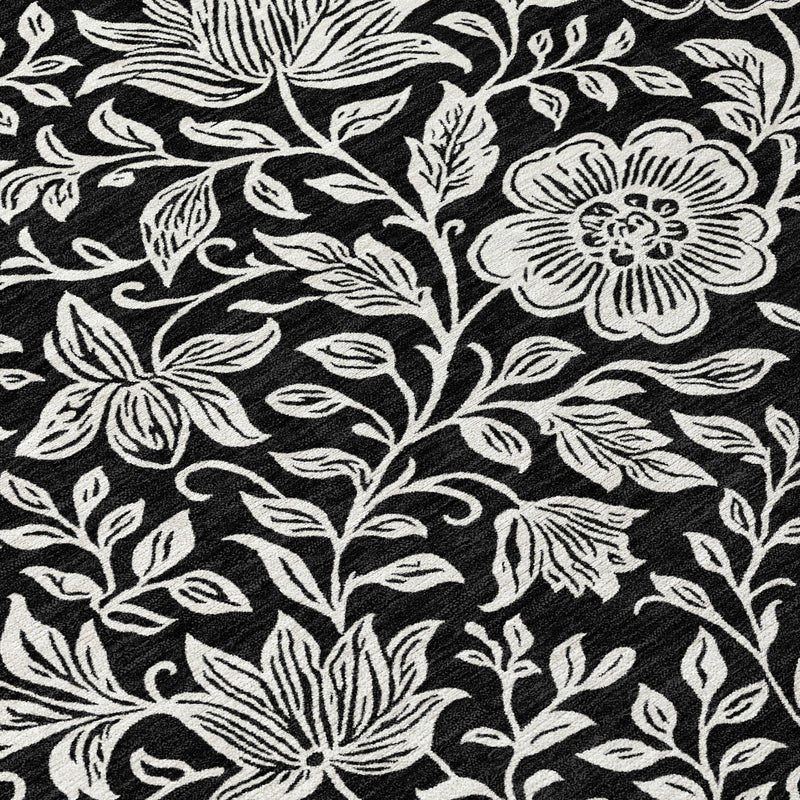 Black and ivory floral area rug with detailed botanical leaf and blossom pattern
