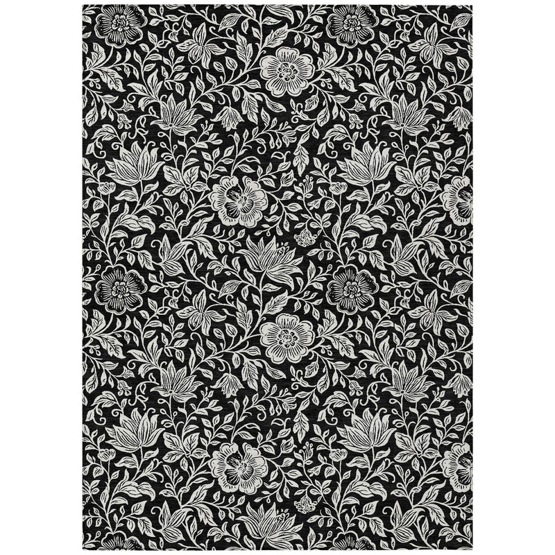 Black and ivory floral area rug with scattered blossoms and leafy vines pattern