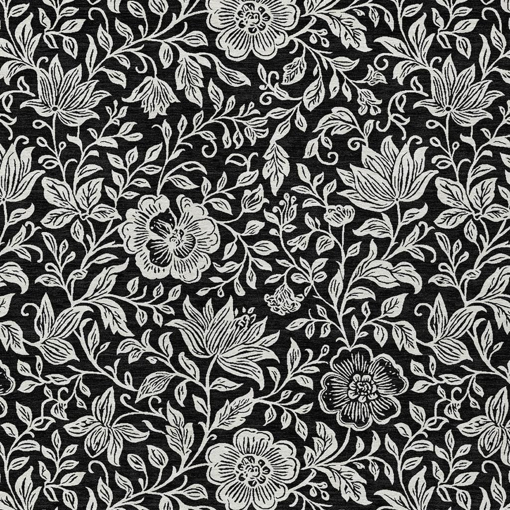 Black and ivory floral area rug with bold leaf and flower motifs in line pattern