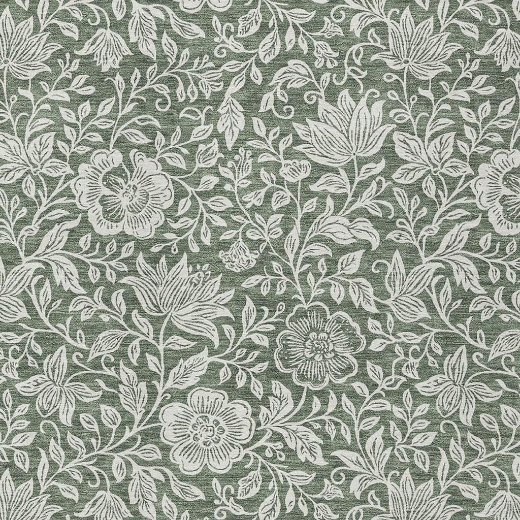 Green washable rug with ivory floral vine pattern, close-up surface detail