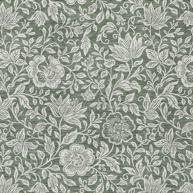 Green washable rug with ivory floral vine pattern, close-up surface detail