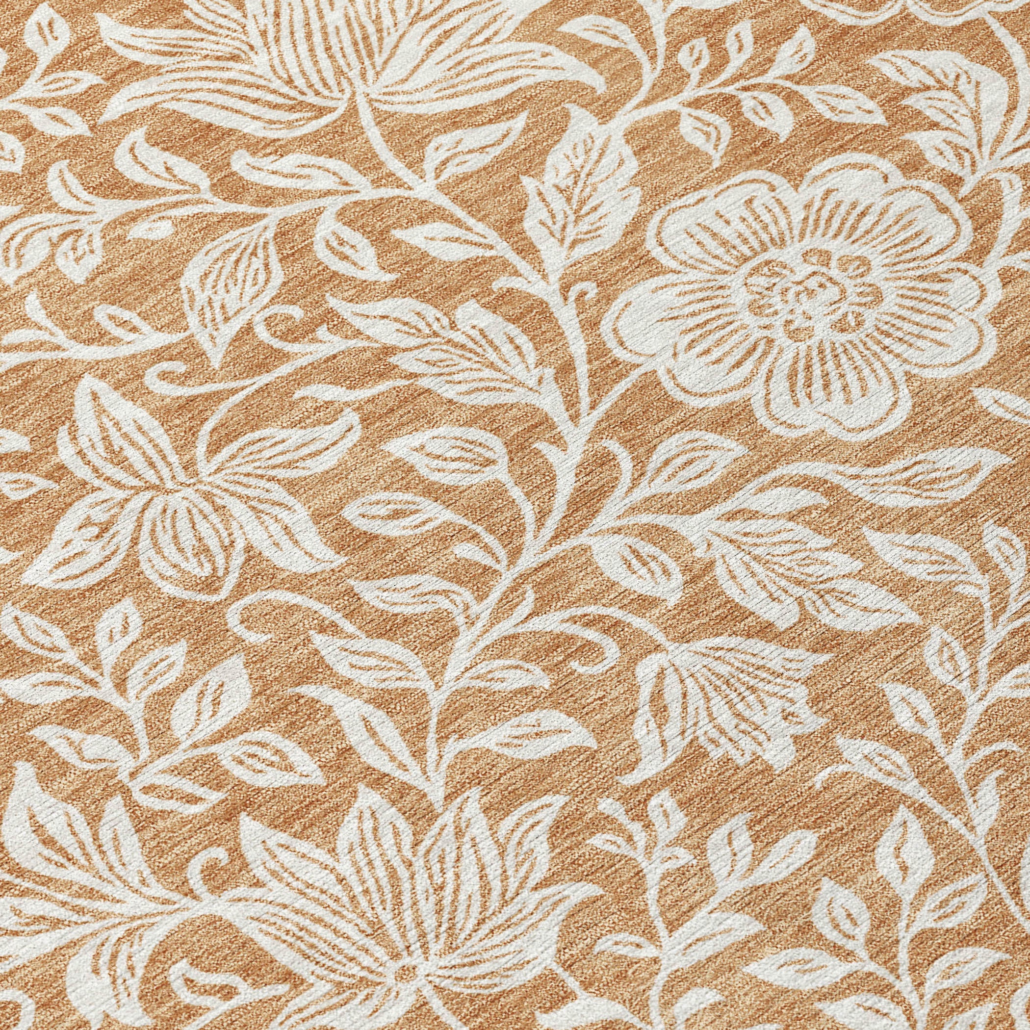 Close-up of round area rug with ivory floral outlines on copper-brown