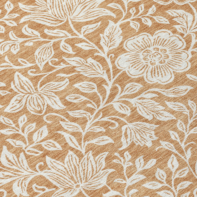 Close-up of round area rug with ivory floral outlines on copper-brown