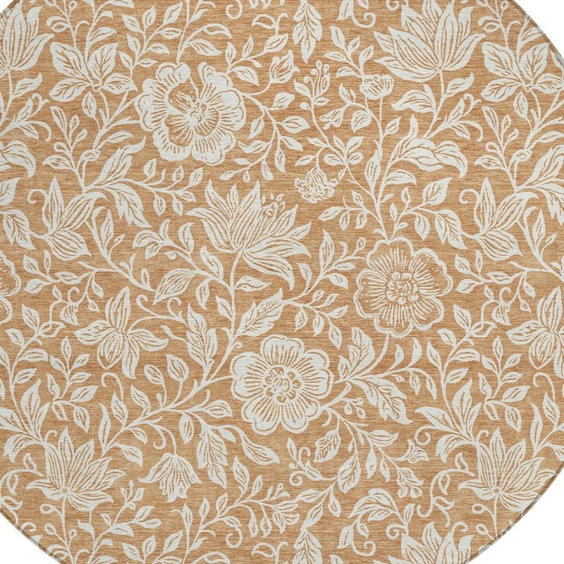 Round area rug close-up, copper-brown background with ivory flower-and-leaf pattern