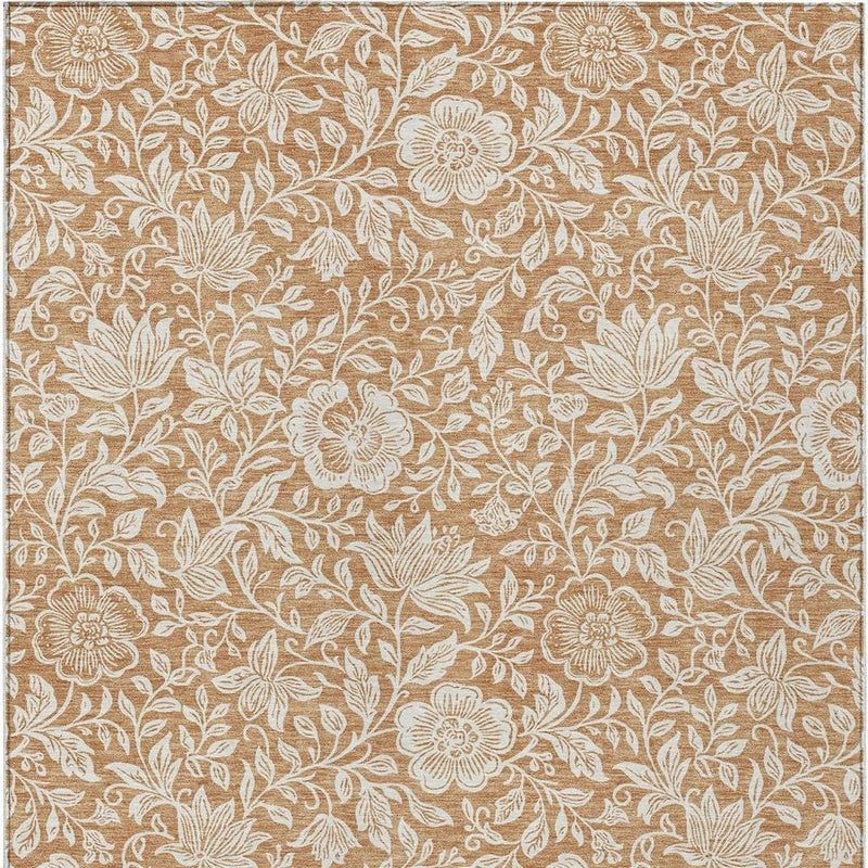 Copper and ivory floral area rug close-up with leafy vines and light flower details