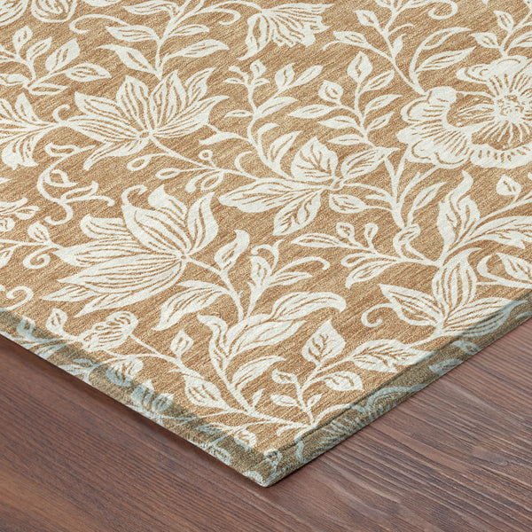 Copper and ivory floral area rug corner on wood floor